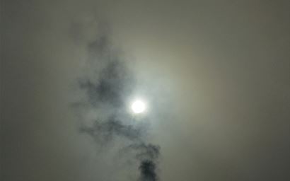 Smoke pollution coming from a chimney of a house