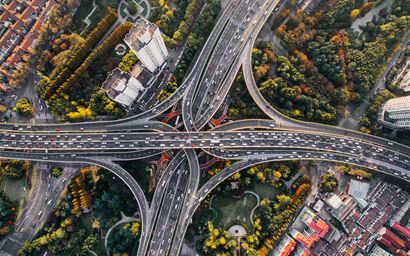 Aerial picture of streets, trees and buildings in a city.