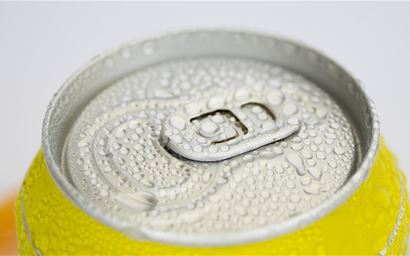  aluminium drinks can with ring pull viewed from above, yellow.