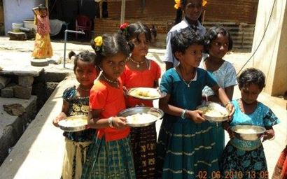 "Children are getting served with food under mid-day meal scheme, in India"