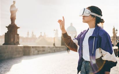 Woman wearing vr headset augmented virtual reality in history city center. Concept of virtual museum.