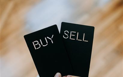 Black cards labelled buy and sell
