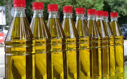 identical bottles of olive oil with red tops.