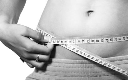 Tape measure across a persons stomach.