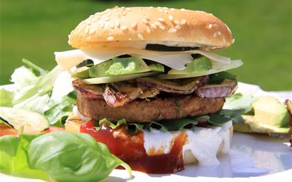 veggie burger in a bun with salad and mayo