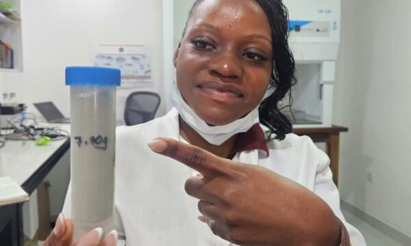 Sihle Blessings Nakombe, a laboratory technician, holds a sample of Metarhizium rileyi used for the biological control of fall armyworm in Zambia.