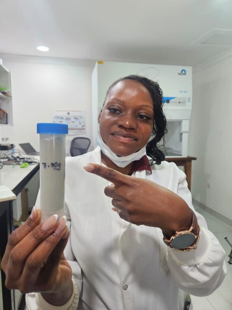 Sihle Blessings Nakombe, a laboratory technician, holds a sample of Metarhizium rileyi used for the biological control of fall armyworm in Zambia.
