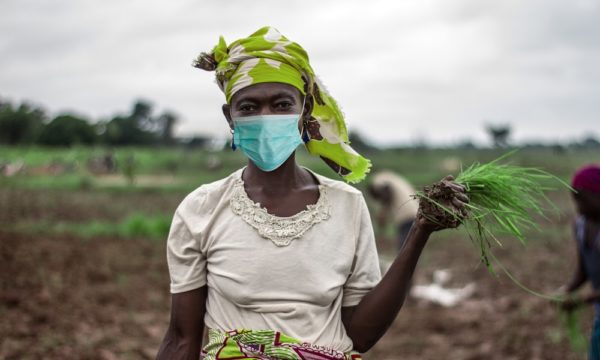 African Woman Farmer with mask