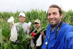 CABI Scientist in maize field with students