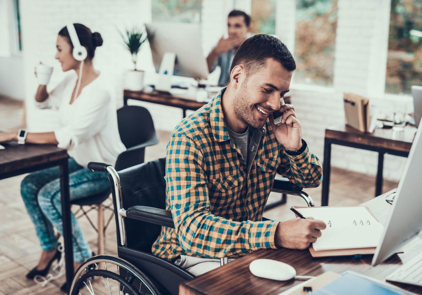 man at desk with wheelchair