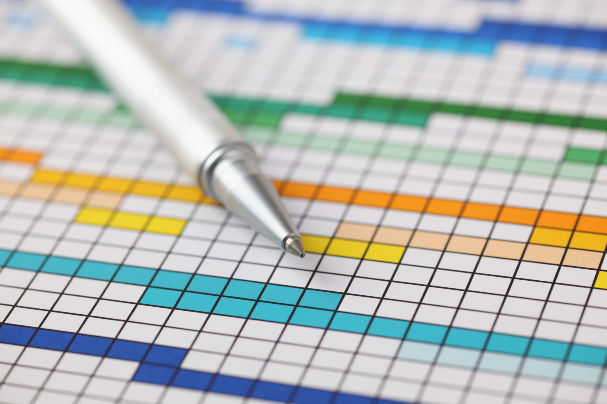 Project Plan Project Plan (Gantt chart) and ballpoint pen on it. Close-up.