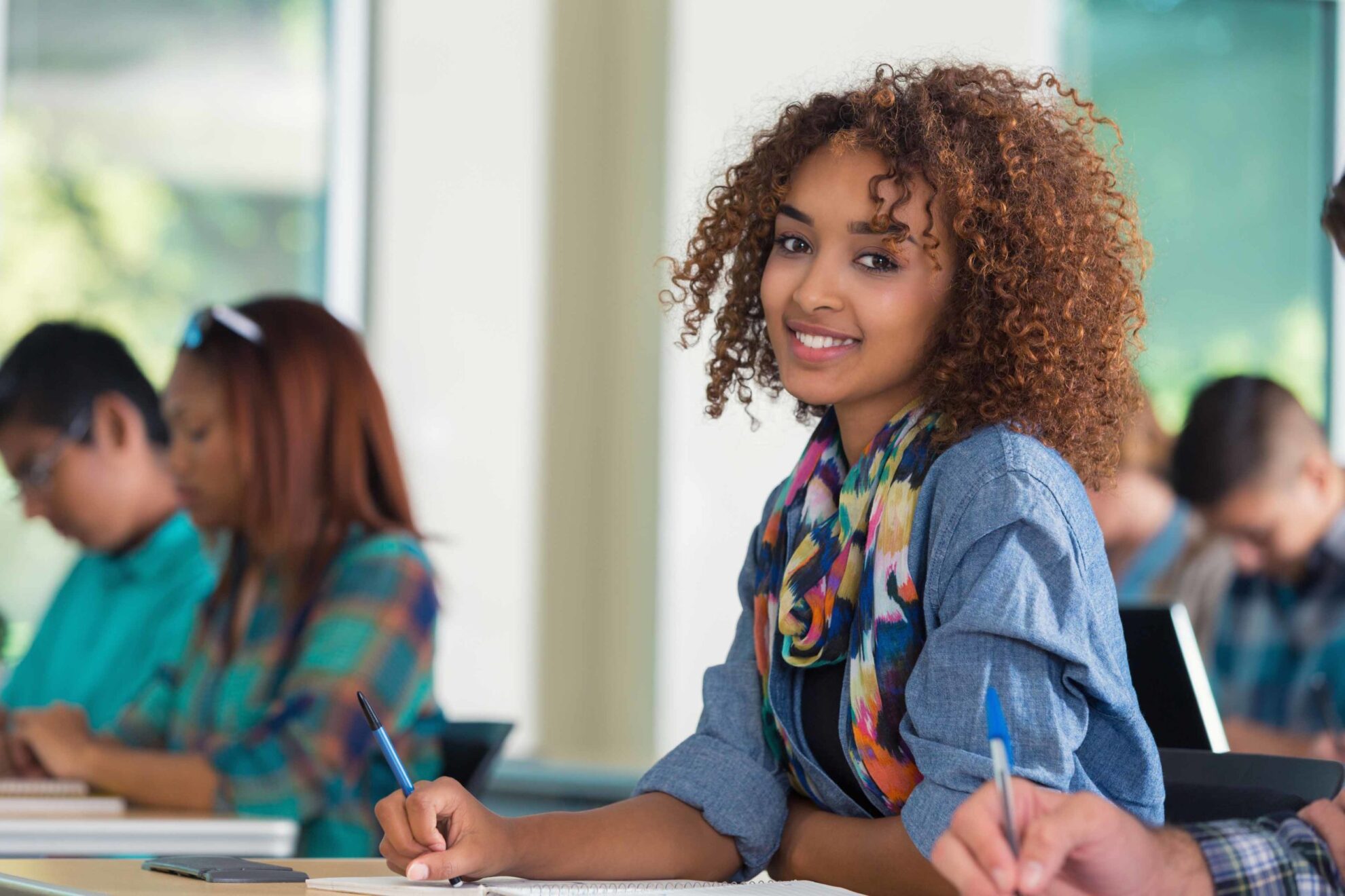 Beautiful African American female teenage college student in classroom Understanding Authorship