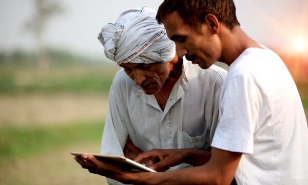 Agronomist consulting with farmer outdoor in the field