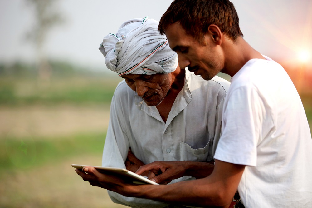 Agronomist consulting with farmer outdoor in the field